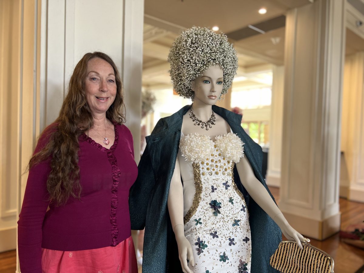 woman standing next to a mannequin 