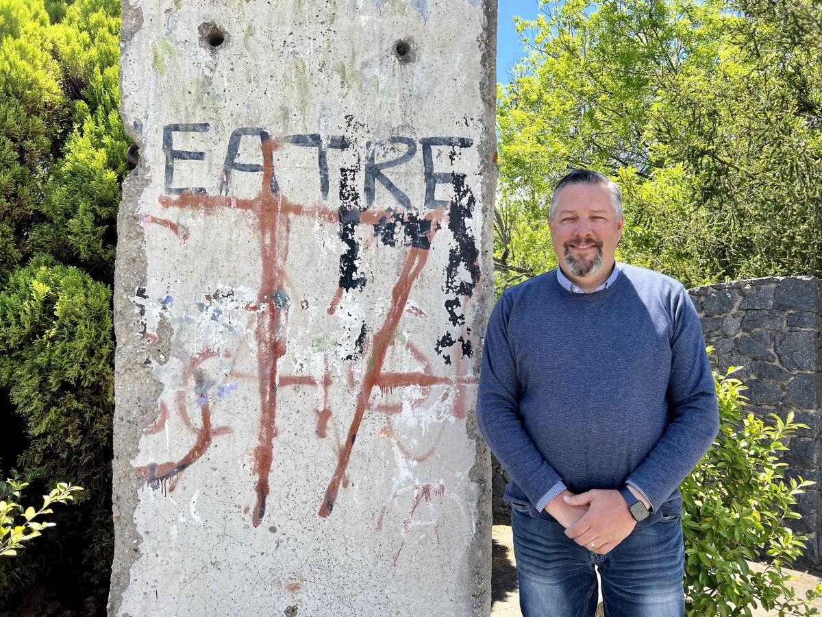 Man standing with concrete wall