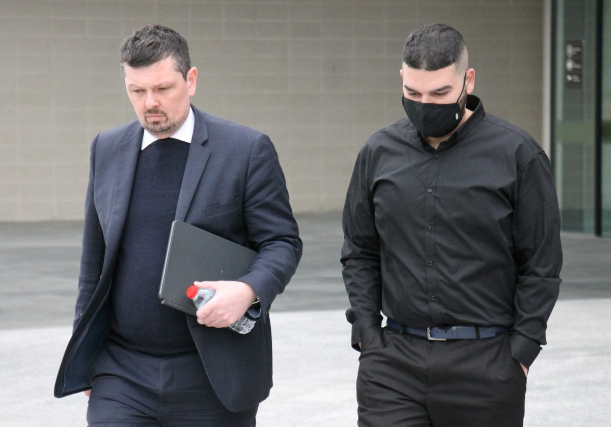 Two men leaving court