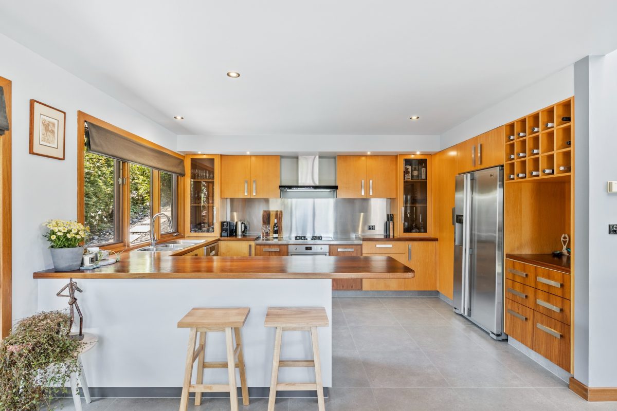 Timber brings out the warmth of the stunning kitchen.