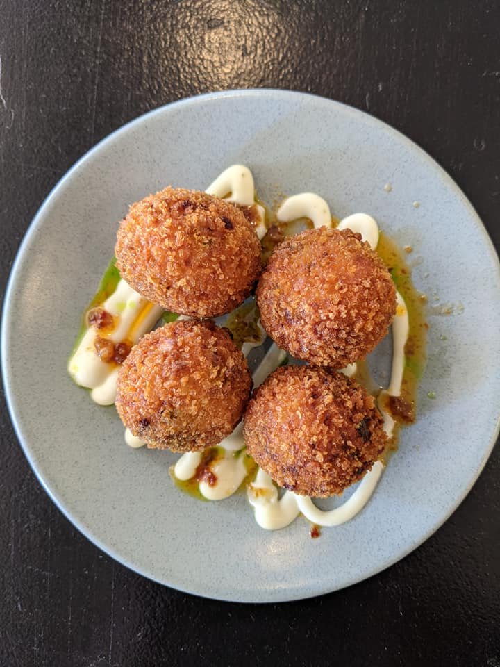 four fried arancini balls