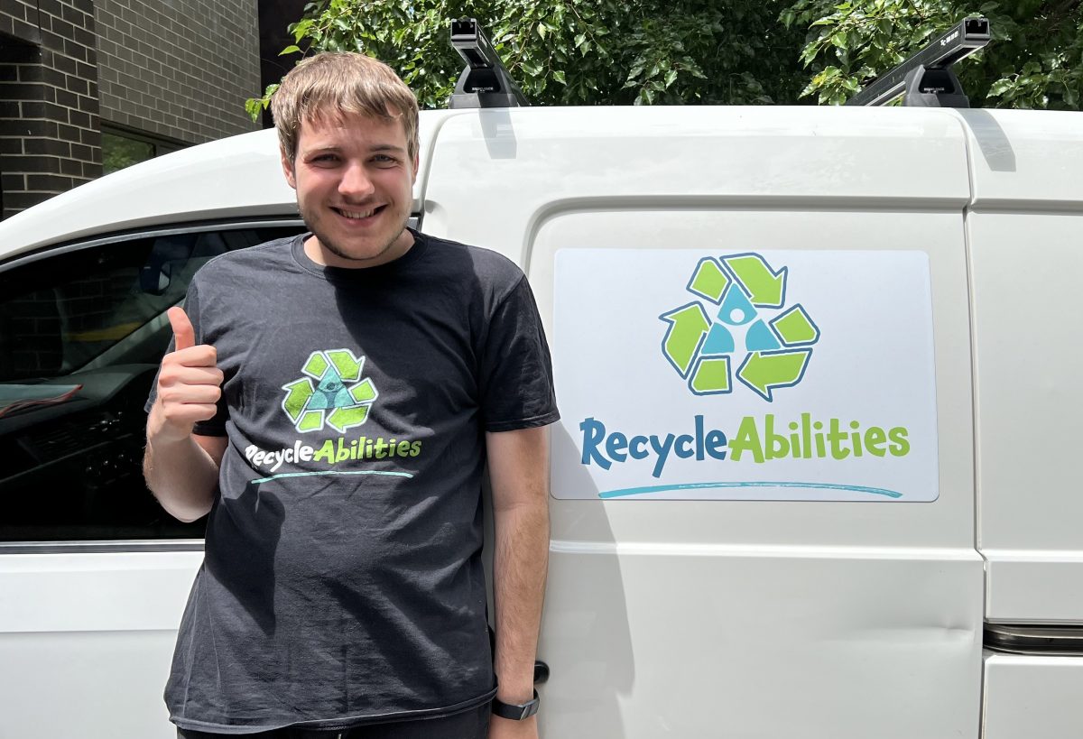 Man next to a van giving a thumbs up