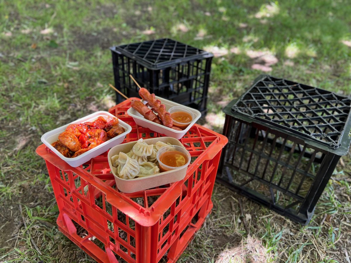 three containers of food on milk crates