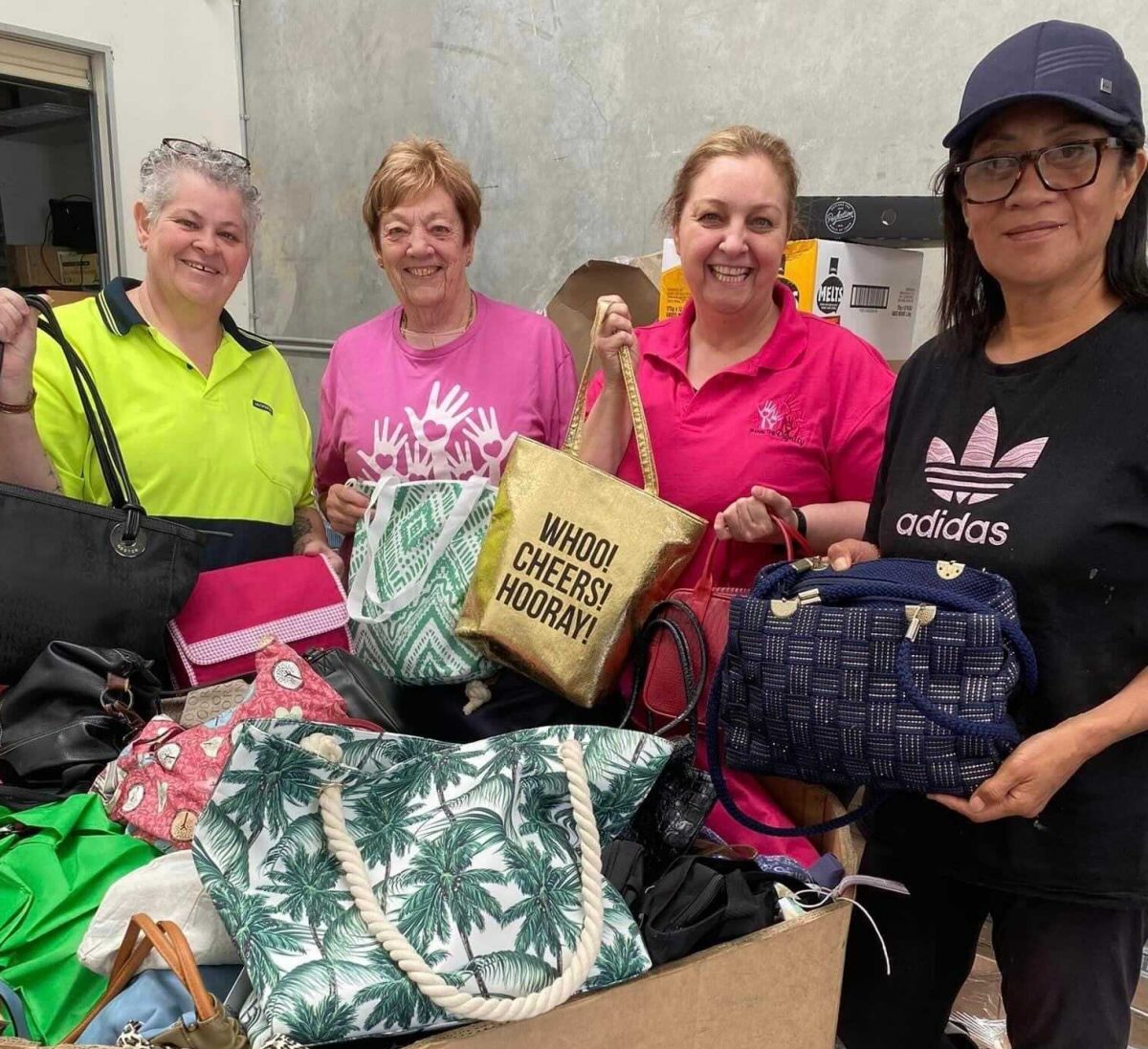 women ready to hand out the essentials bags