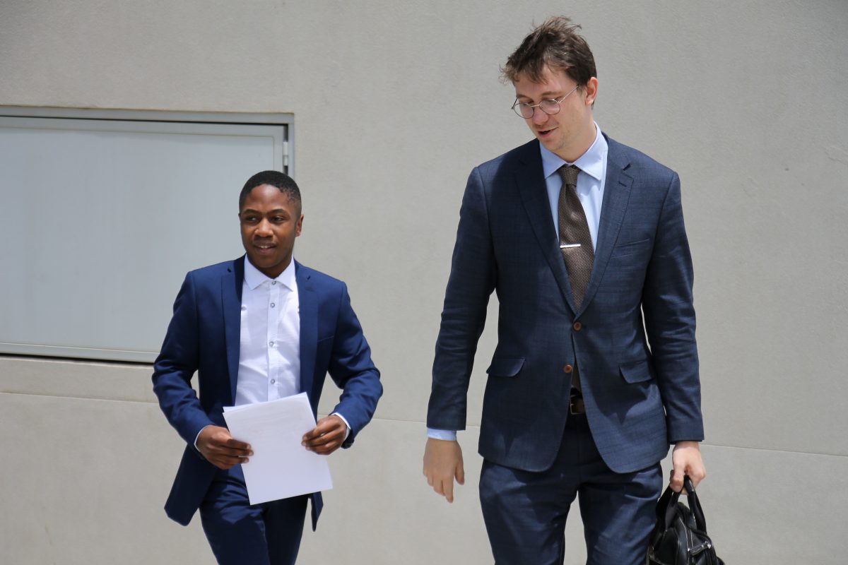 Two man leaving court