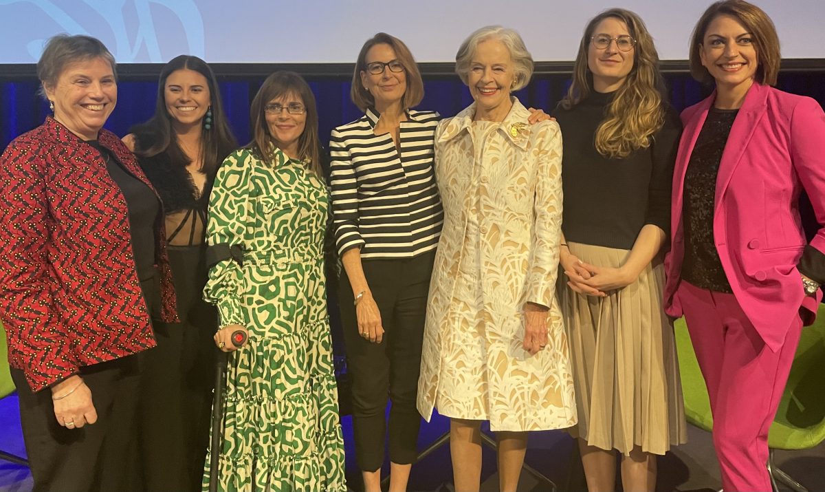 women standing on stage.