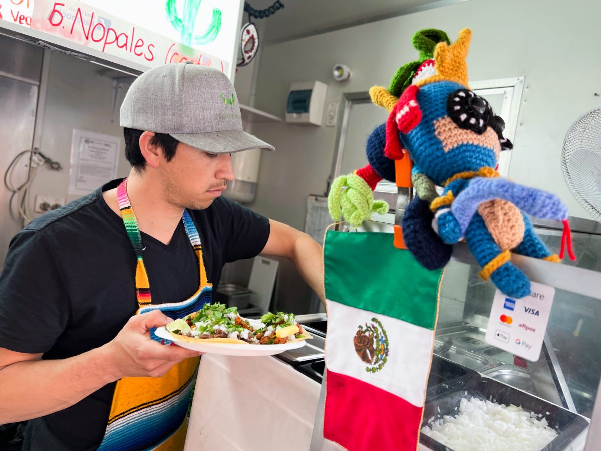 A man putting food onto a paper plate