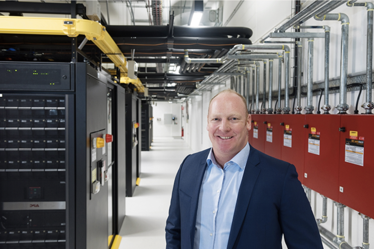 Greg Boorer standing in a data bank