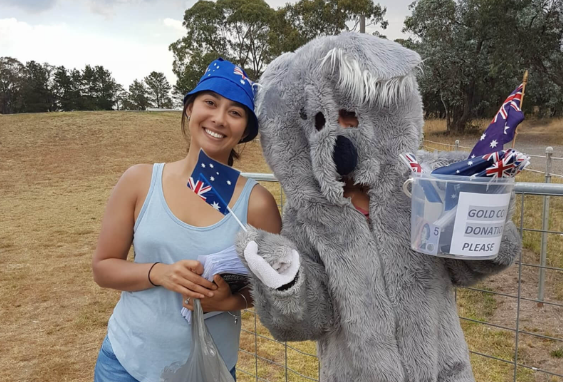 girl standing next to koala
