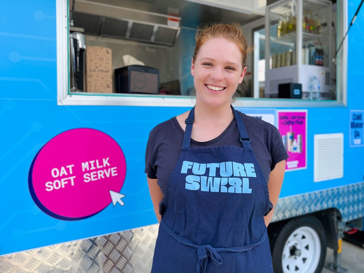 woman smiles in future swirl apron