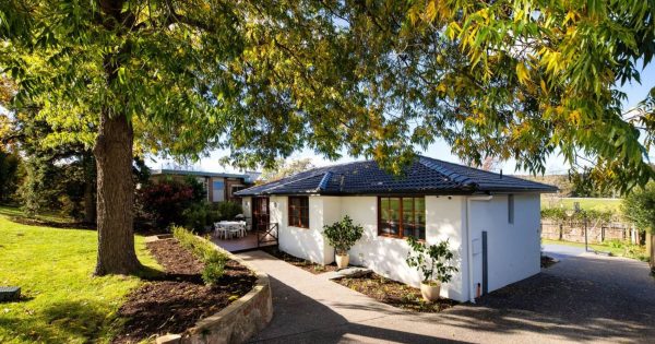 Step inside this cottage-like, contemporary Curtin home surrounded by beautifully landscaped gardens