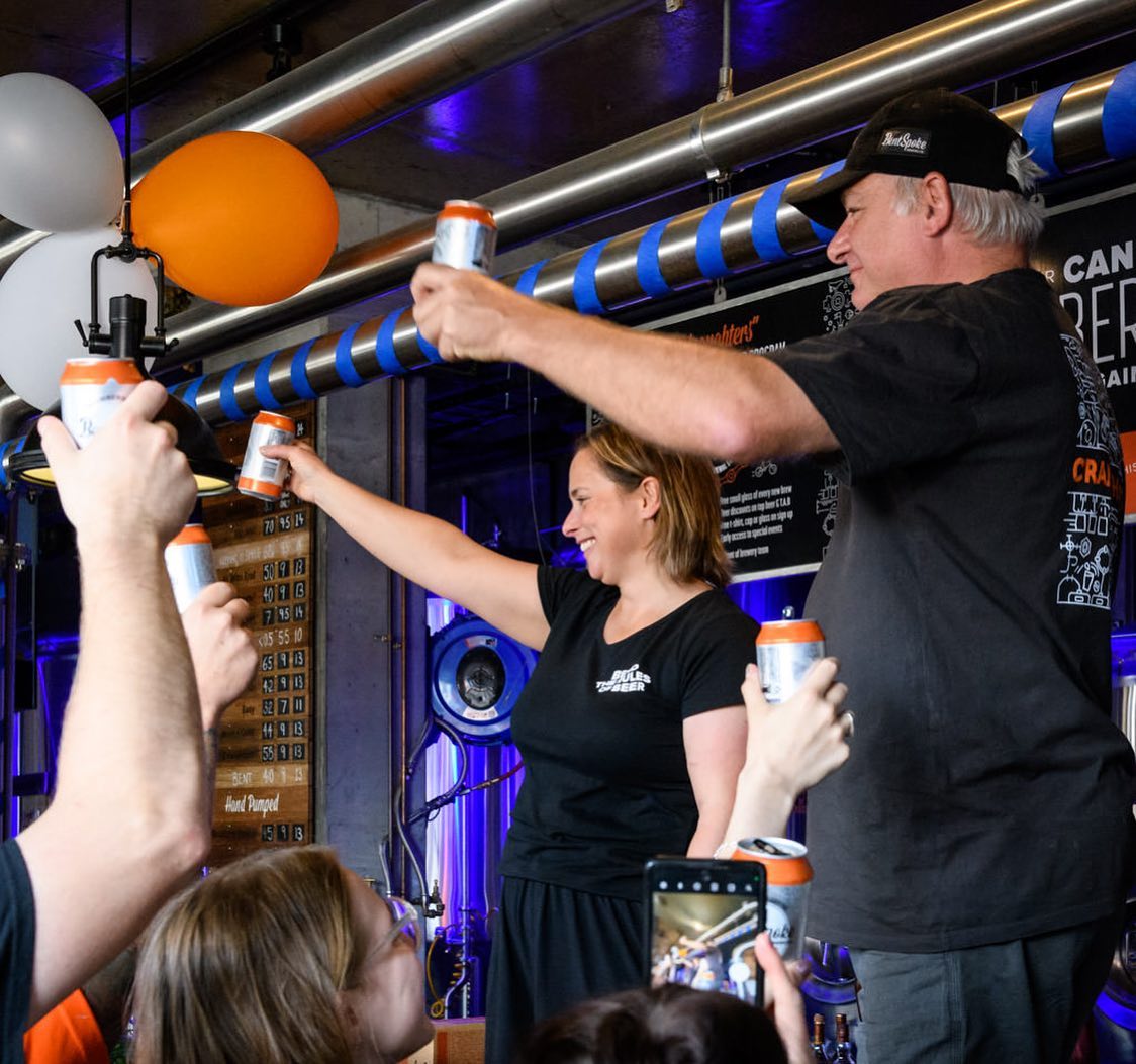 People holding beers at Bentspoke Bewery