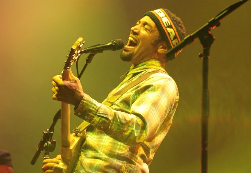 Ben Harper playing guitar on stage