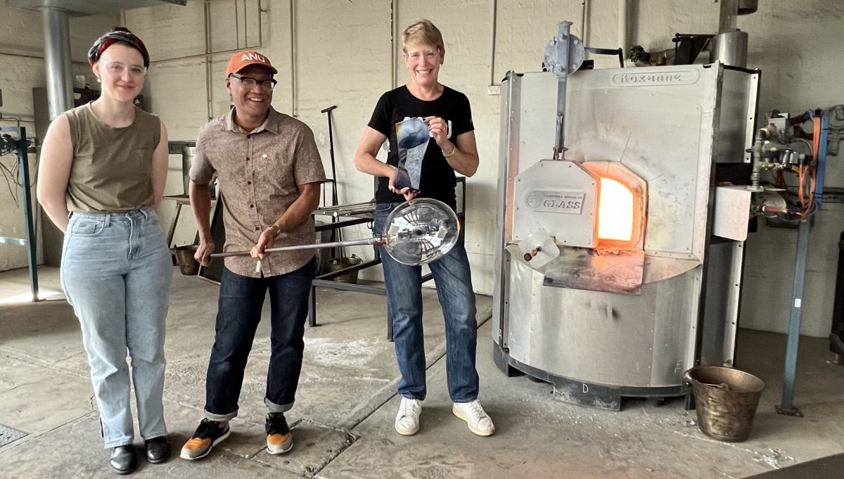 Three people making glass