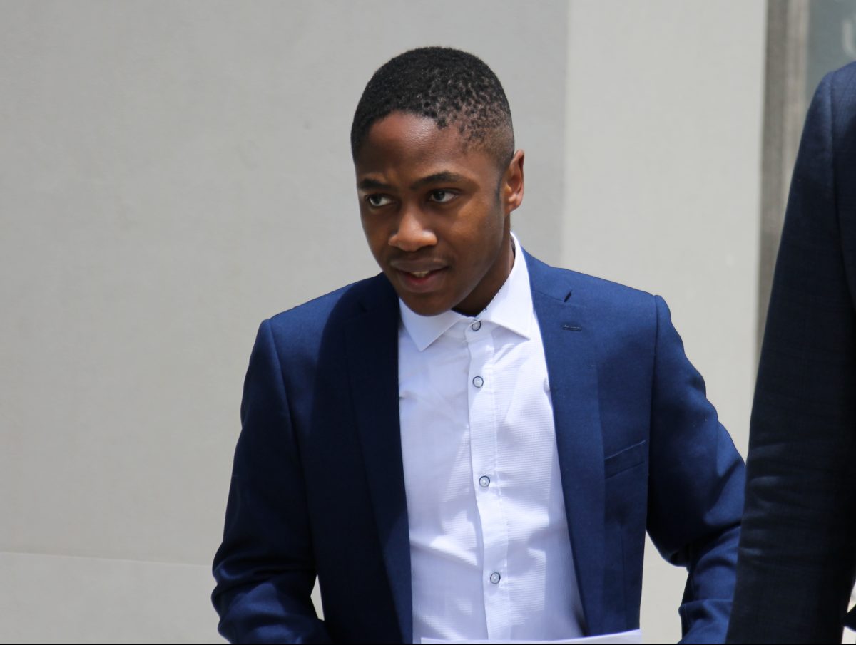young man in suit leaving court