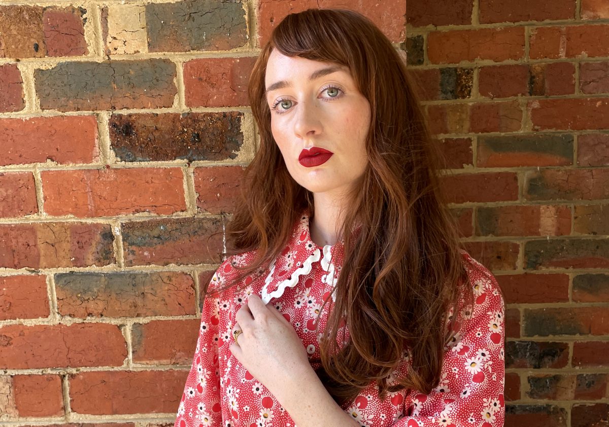 Woman in front of a brick wall