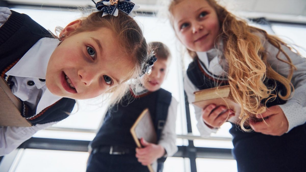 School children looking at a camera