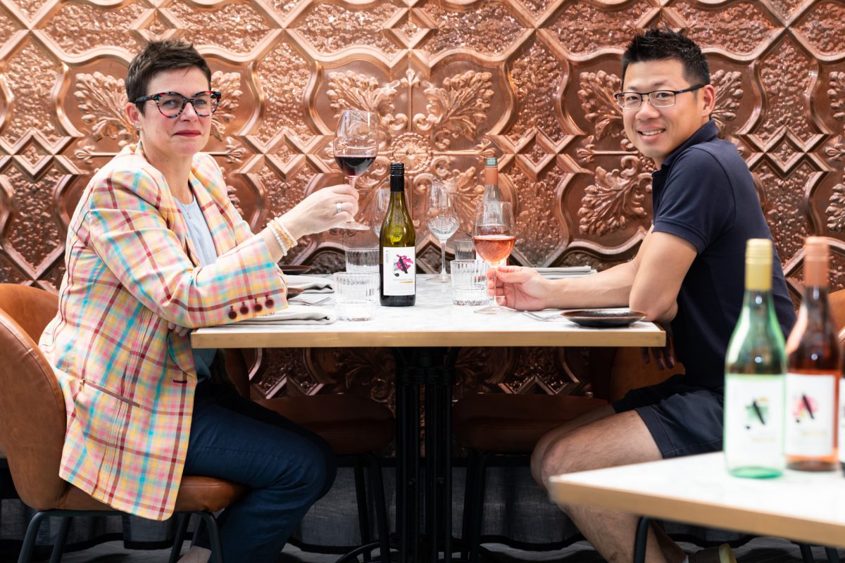 two people enjoying wine