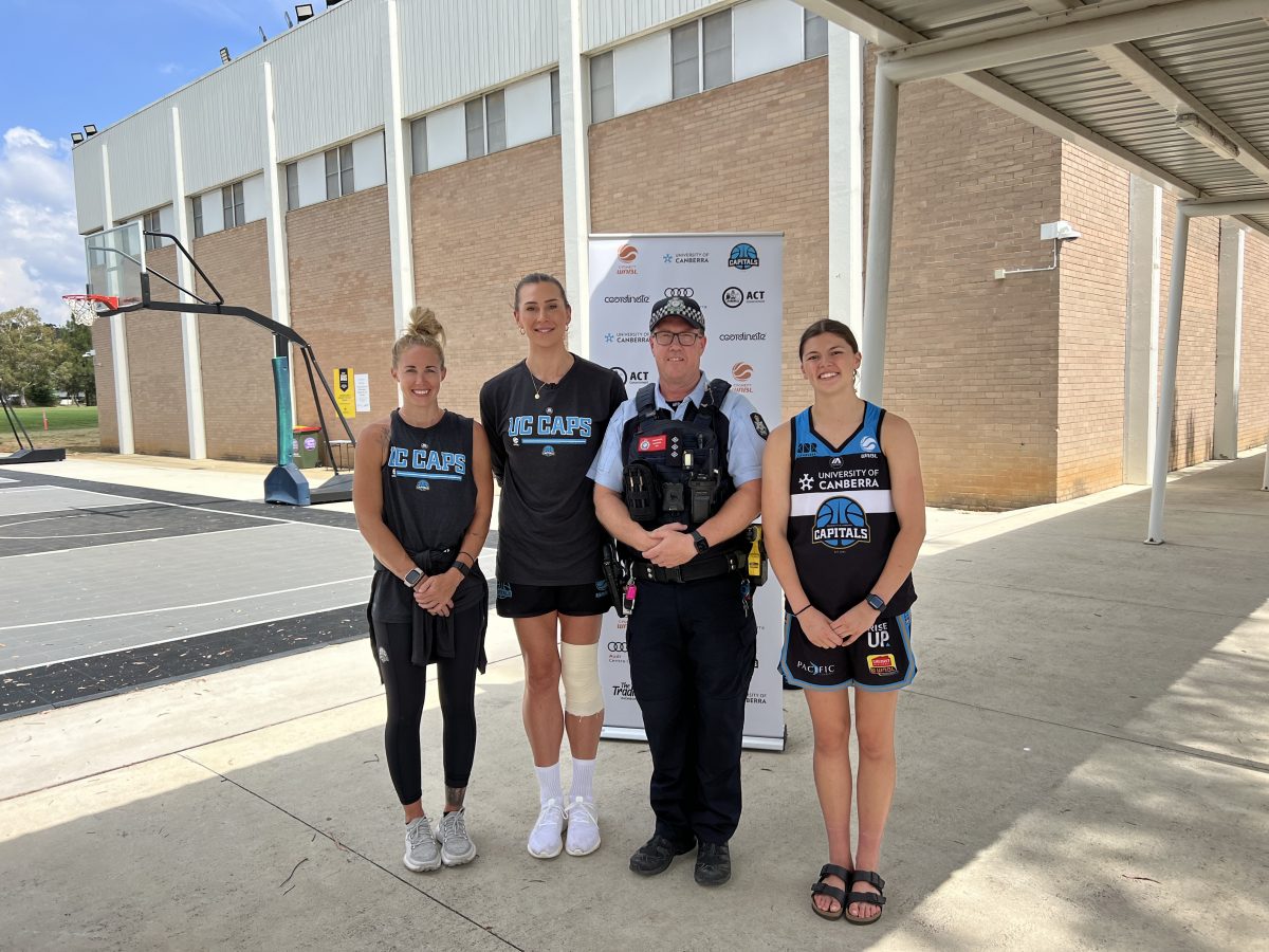 female basketball players with police officer