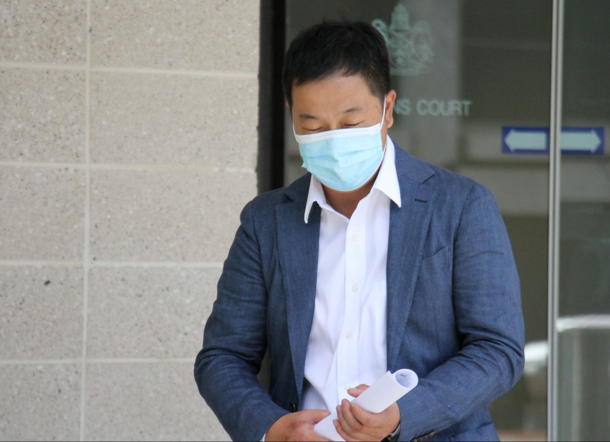 man leaving court wearing a mask