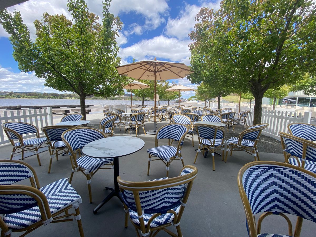 Margot Bar's blue and white seating with umbrellas by Lake Burley Griffin