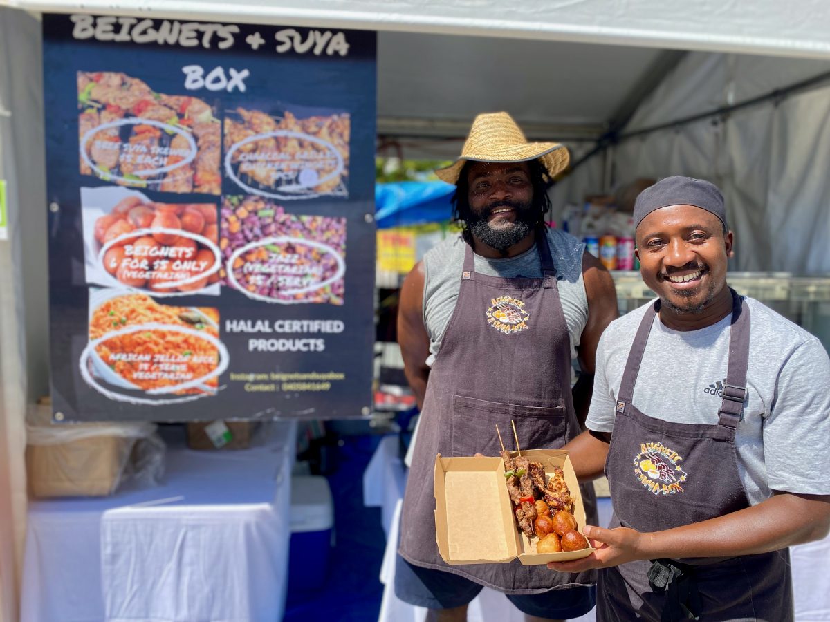 Two men holding African food