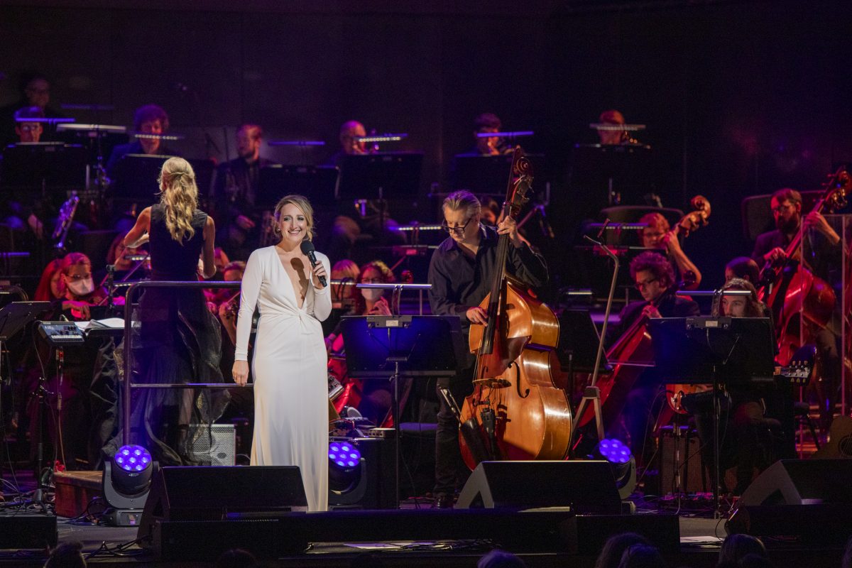 Woman on stage with orchestra