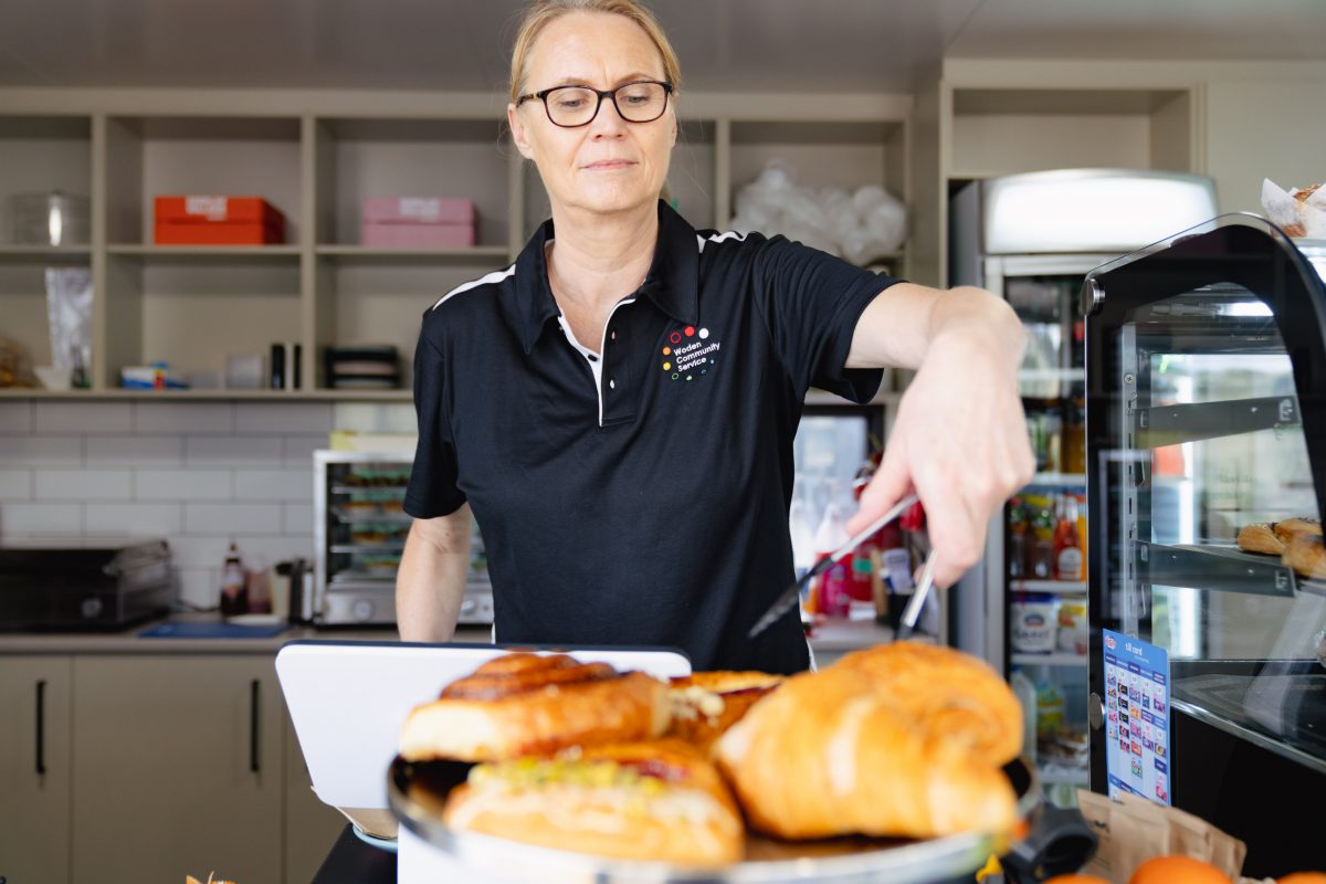 person serving pastries from a cafe