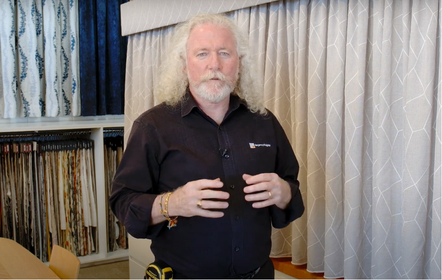 Martin Smith in front of a curtain and pelmet display at the Regency Knights showroom