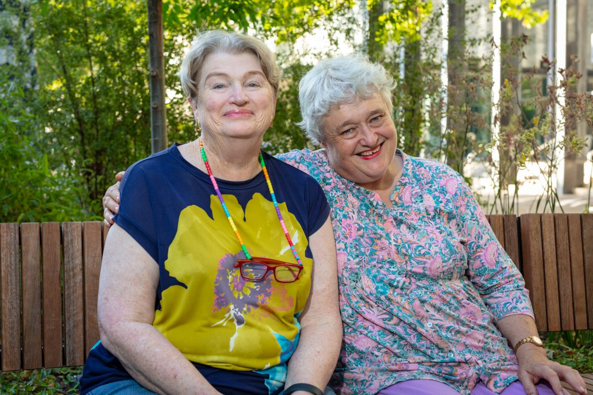 two women sitting on a bench