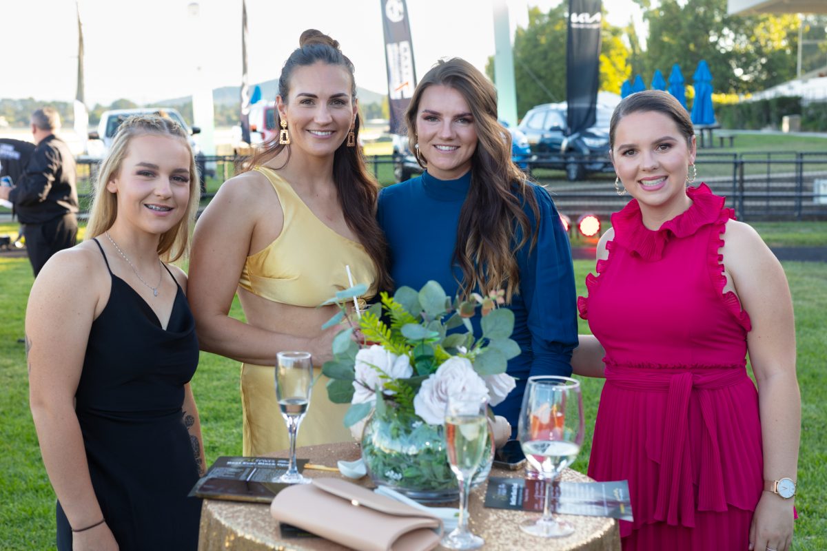 four people standing at Thoroughbred Park racecourse