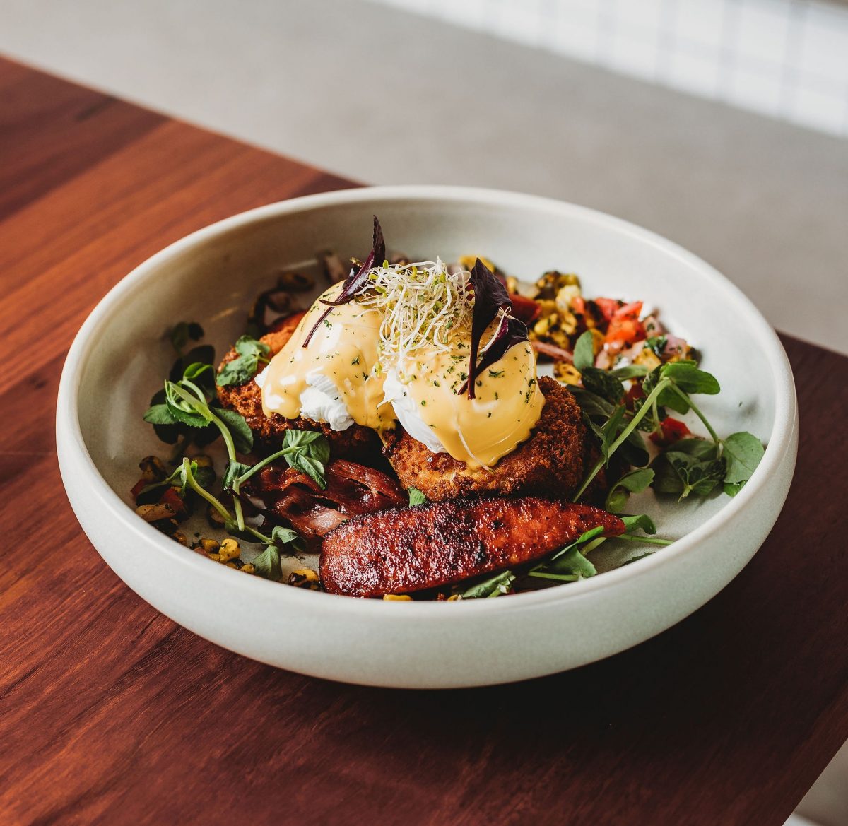 Beautiful bowl of fritters, eggs and hollandaise sauce.