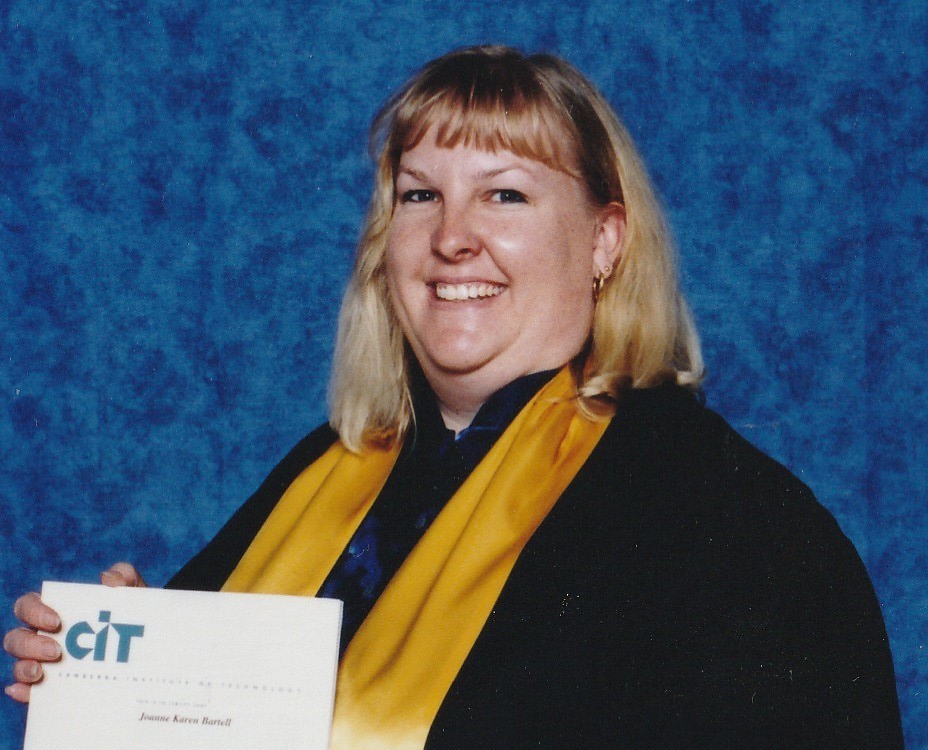 Jo Bartell at her CIT graduation ceremony, holding her certificate