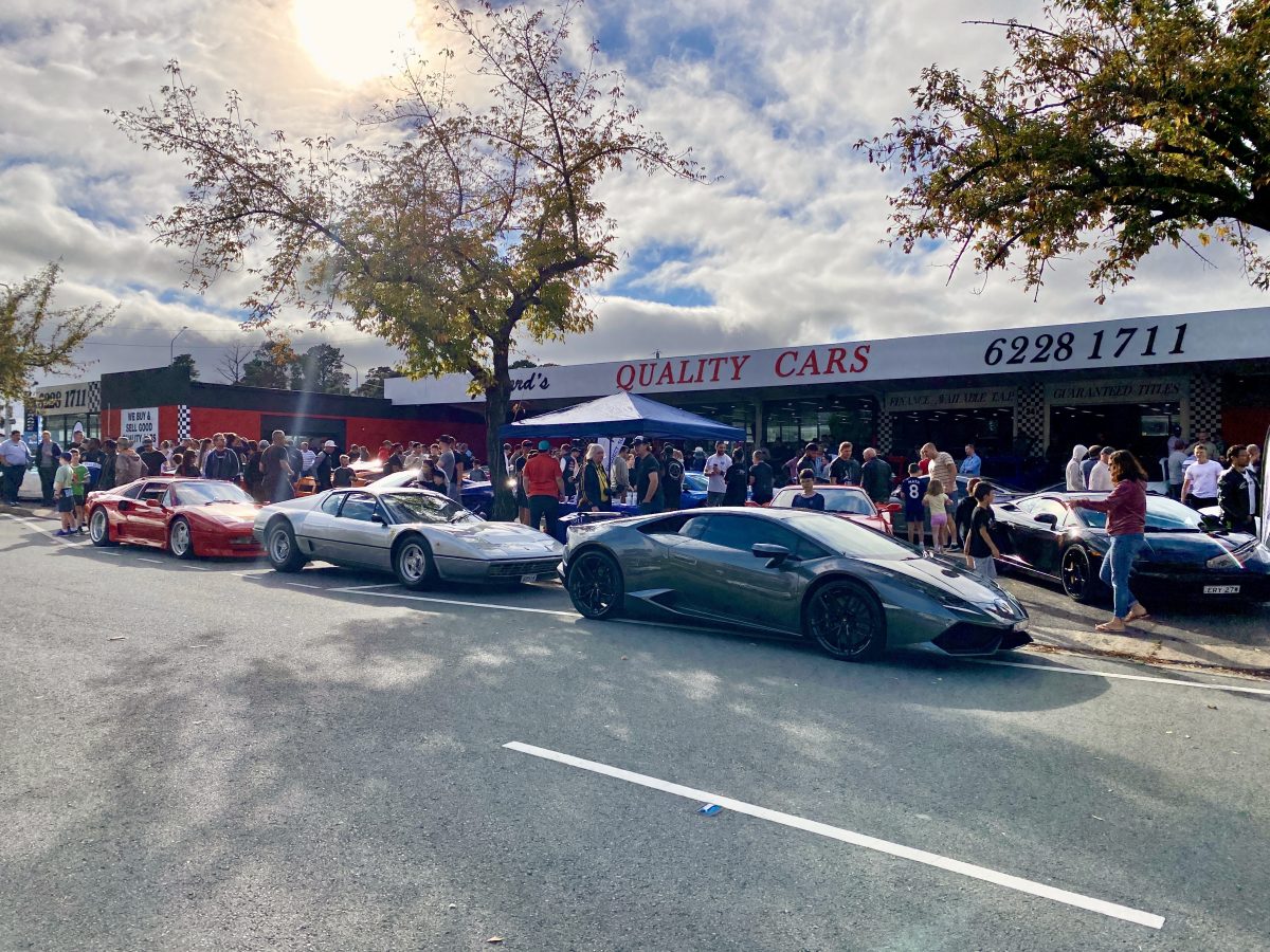 Supercars parked outside a car dealership