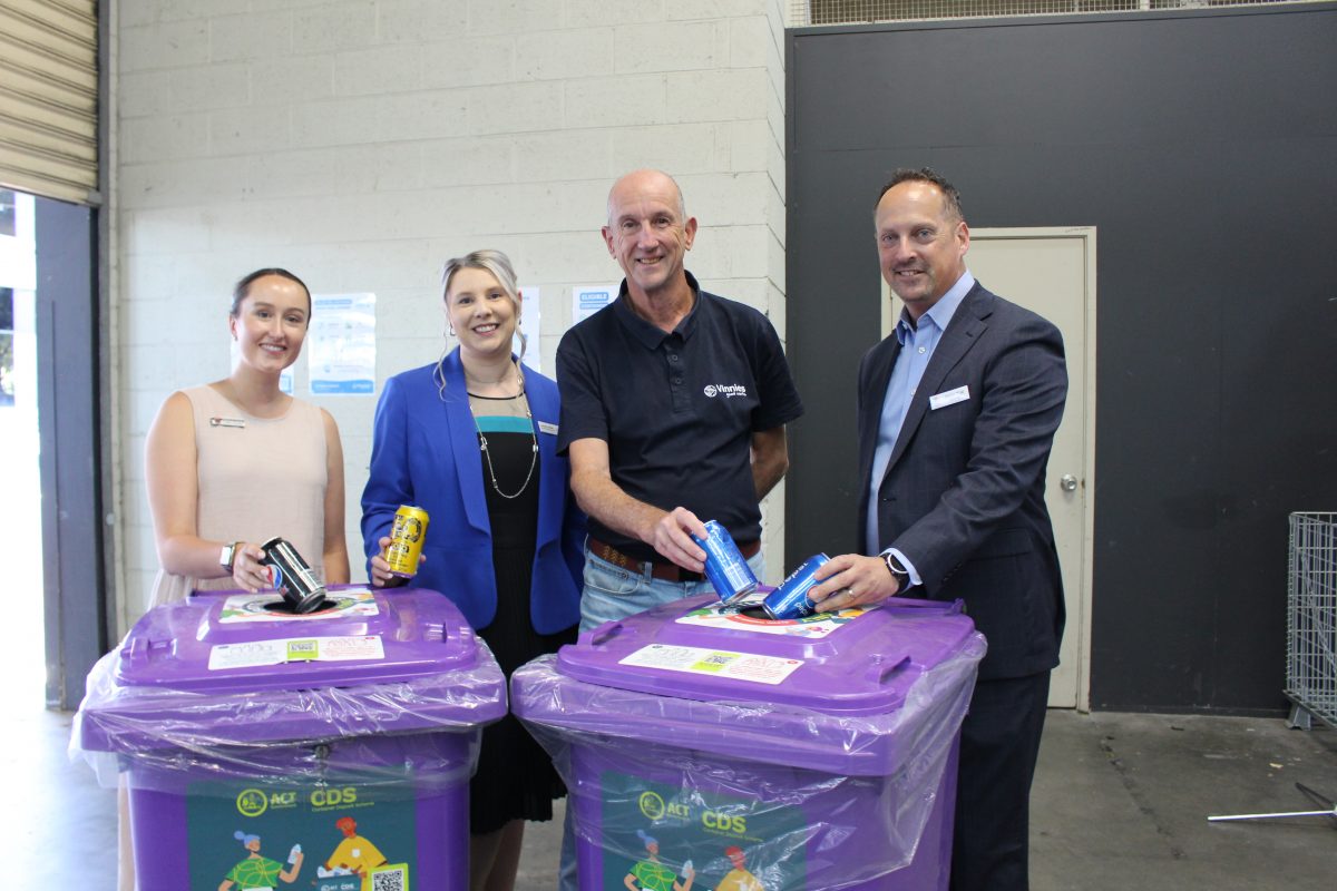 Caitlin Semmler, Rachel Swain, Stuart Davis-Meehan and Stephen Wood put cans in Recollect bins for the Caring for Canberra container deposit scheme.