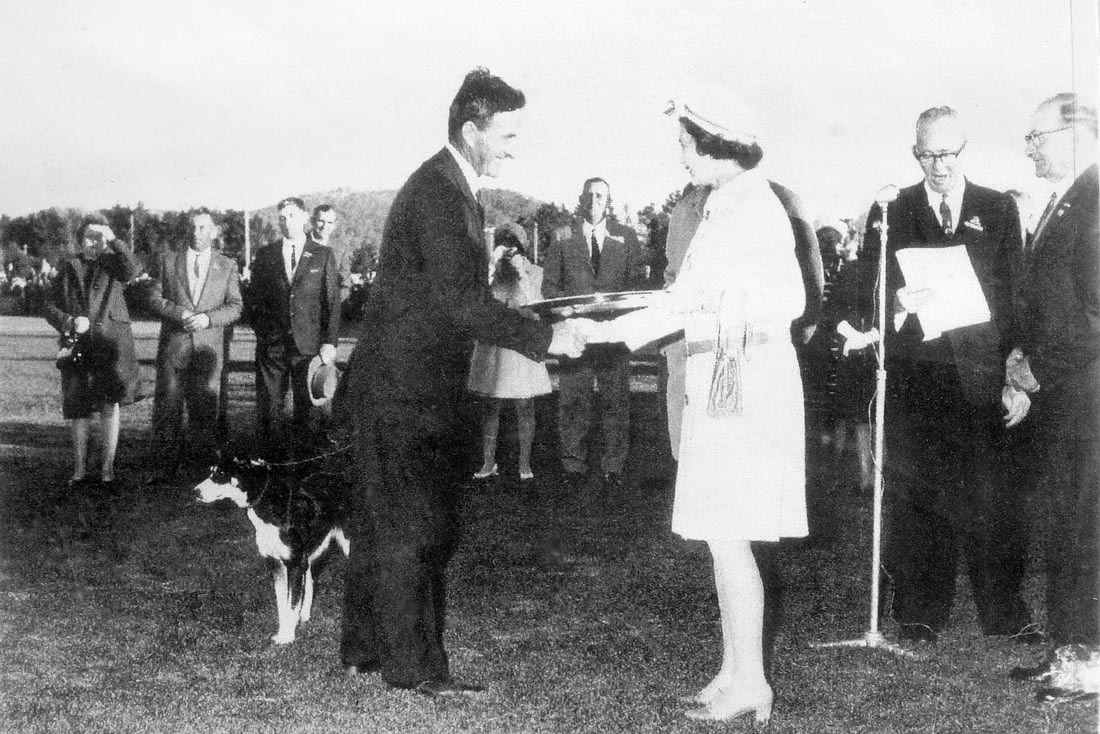 Queen presents award to man and dog