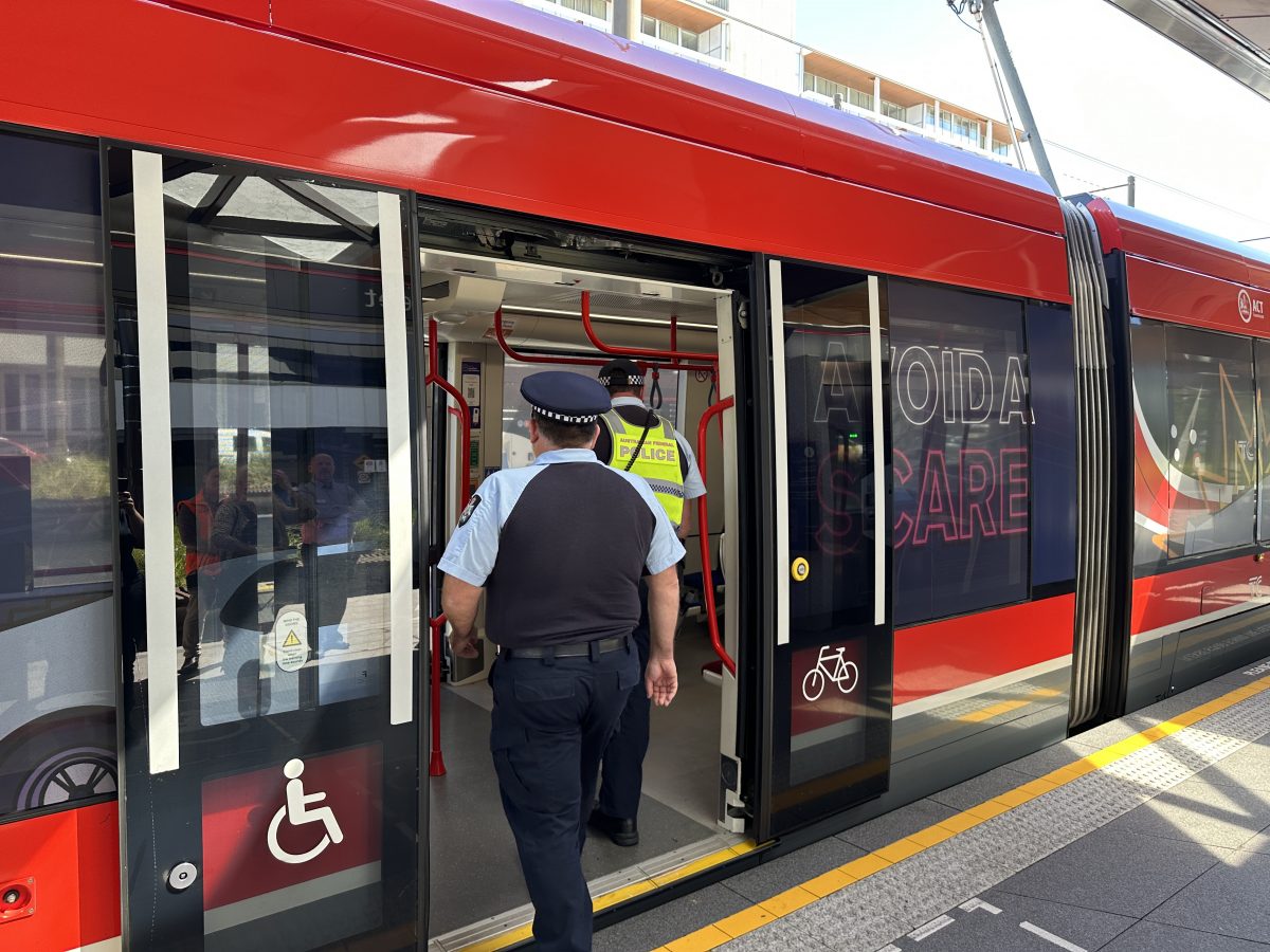 ACT Road Policing Detective Inspector Paul Hutcheson and Acting Sergeant Damian Watson entering a light rail train