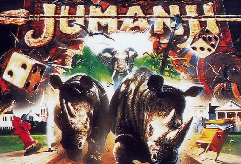 A movie poster with two dice, a board game, two rhinos running at the camera and text at the top: 'Jumanji'