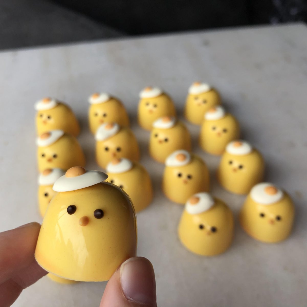Small, yellow hens made of chocolate. 