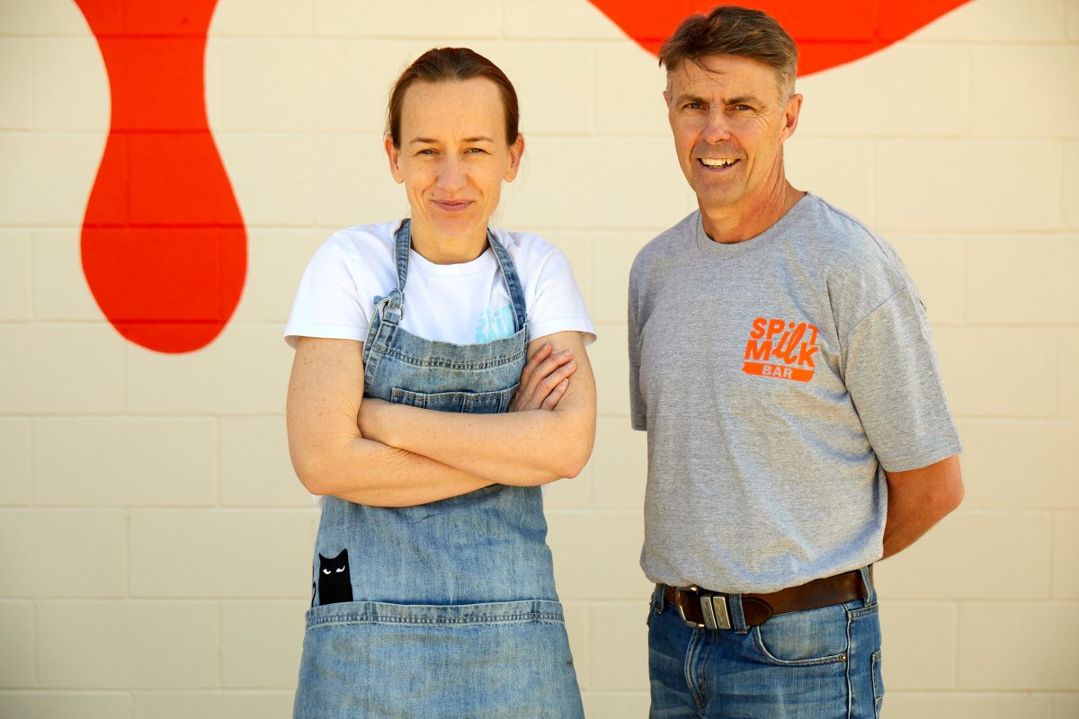 Two people pose in Spilt Milk uniform