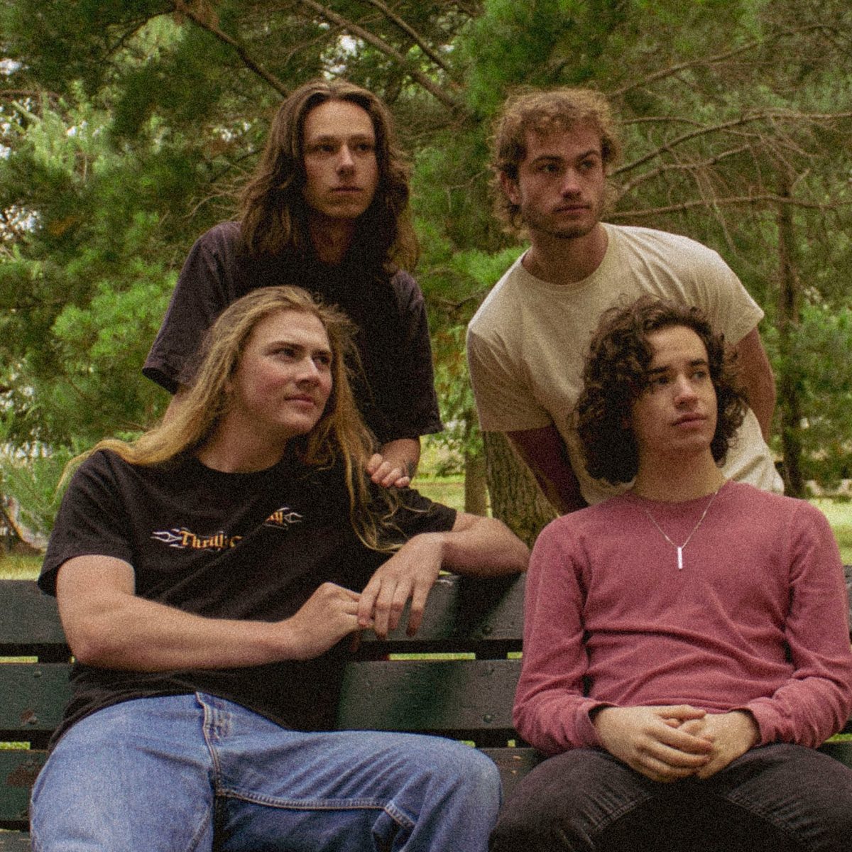 four men around a park bench