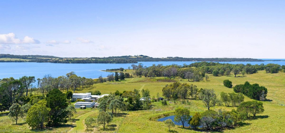 Aerial view of property next to a lake