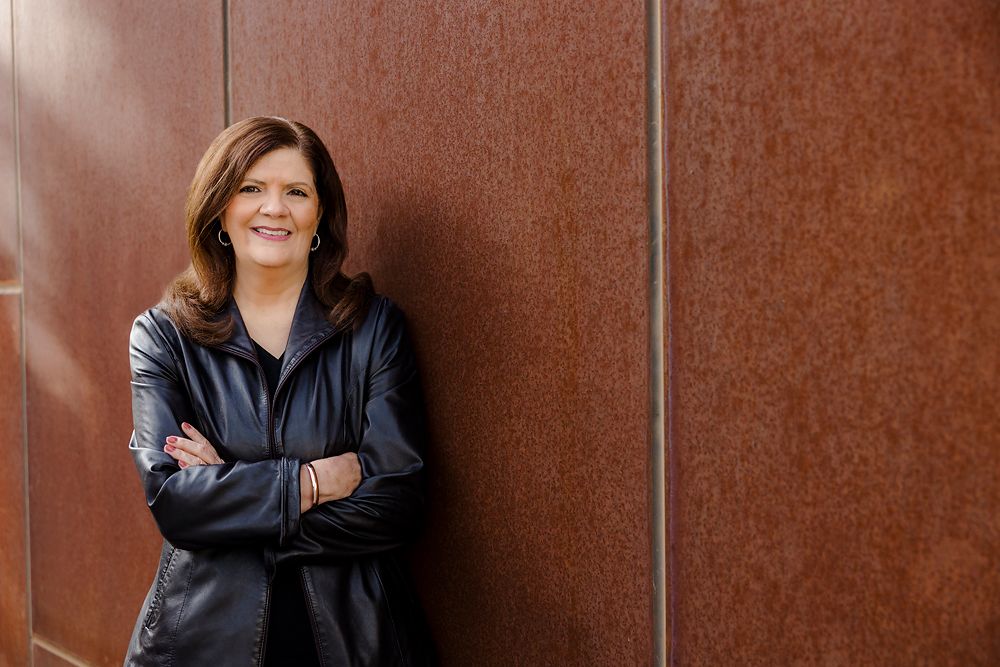 woman smiling leaning against wall