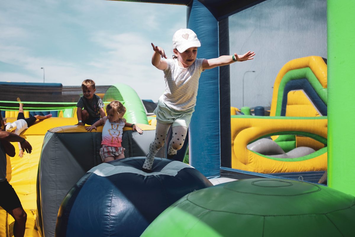 Kids playing on the inflatable obstacle course