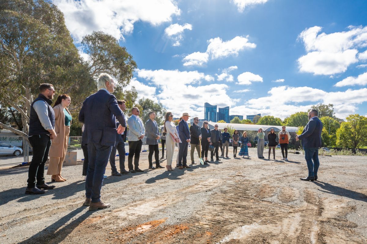 man giving speech at building site