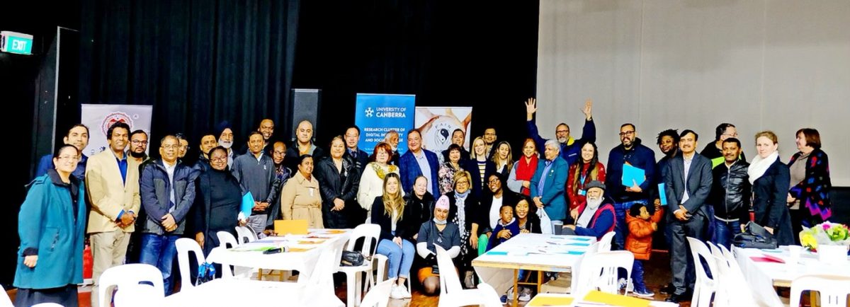 crowd of people at symposium posing for group photo