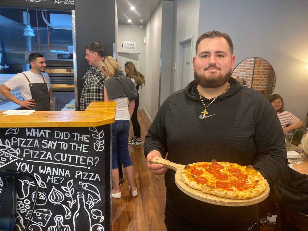 Man holds pizza