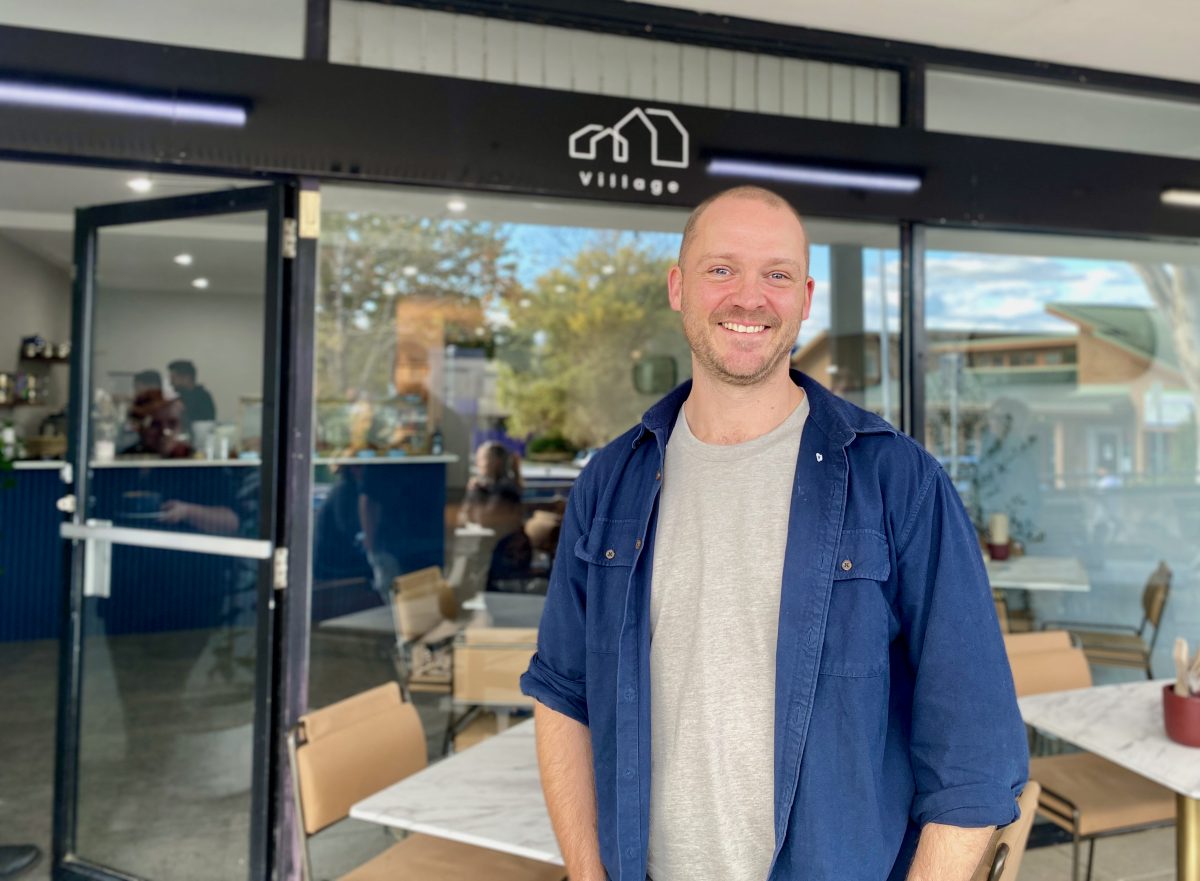 Neil standing at exterior of Village Cafe Waramanga