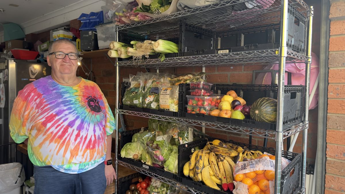 Paul McGrath in front of the fresh food offered by the street pantry.