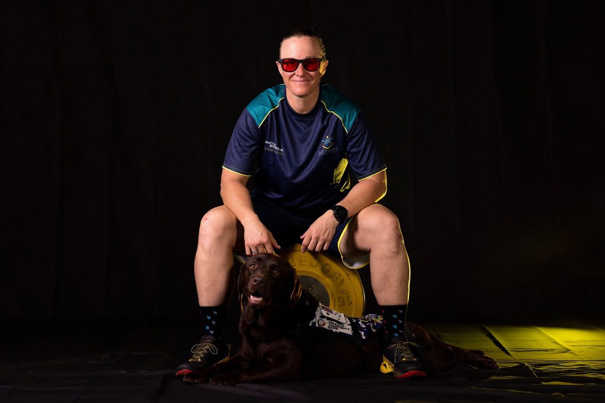 Taryn Dickens and her assistance dog Gigi.